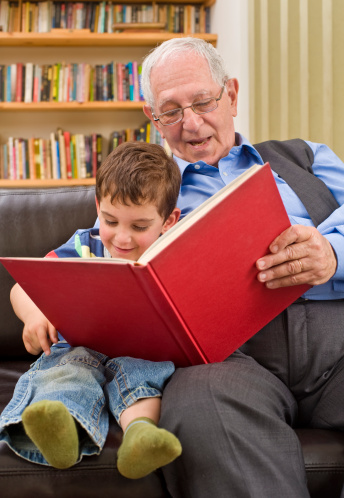 grandfather reading a story to his grandchild