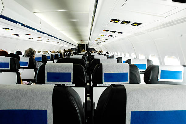 istock People sitting in aeroplane, rear view 147037866