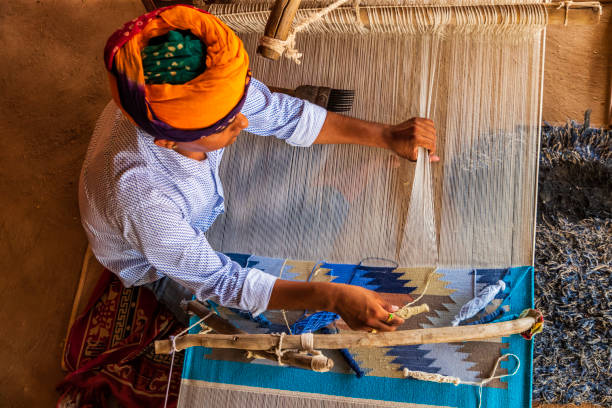 istock Indian man weaving textiles (durry) in Rajasthan 1470378888