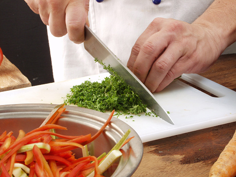Cutting parsley in a kitchen.