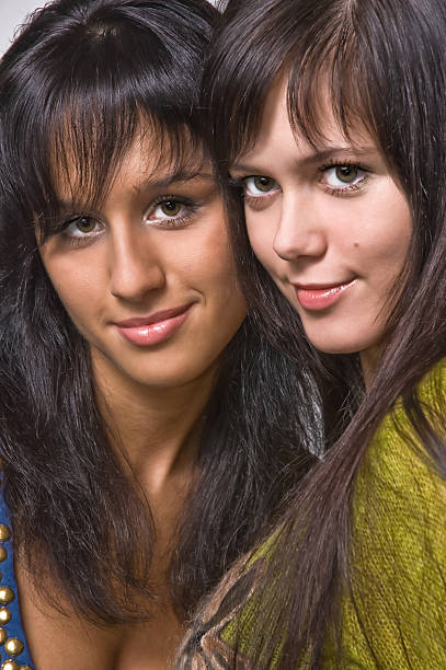 Two beautiful brunettes close up stock photo