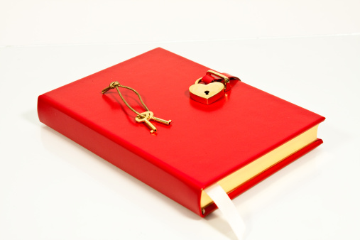 Red diary locked with heart shaped lock.