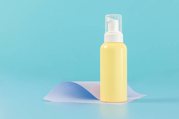 istock Yellow bottle with a dispenser on a blue background. 1470383305