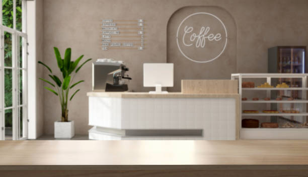 istock Empty wooden counter, tabletop in modern, luxury design cafe with white counter, espresso machine, cash register, cake display refrigerator in sunlight on brown wall 1470383450