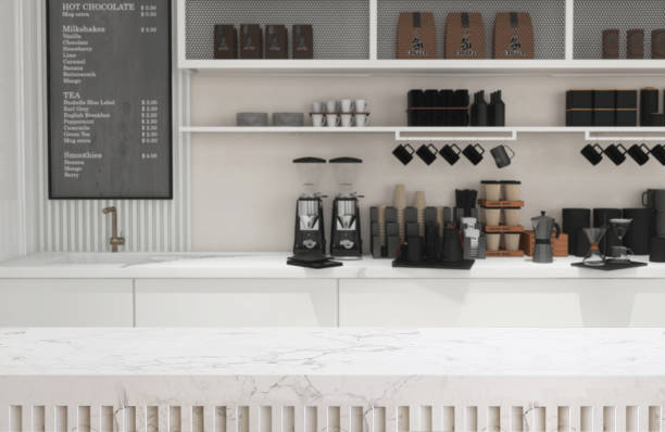 istock Empty white marble counter, tabletop in modern, luxury design cafe with cabinet, sink, cupboard shelf and grinder in sunlight on wall with menu board 1470383455