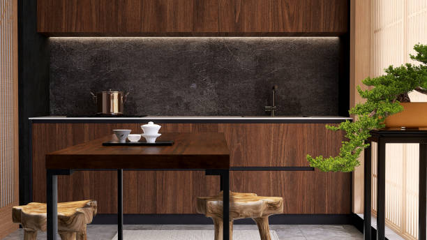 istock Luxury, modern beautiful wood grain wooden counter, black granite splashback, cupboard, dining table, natural shape chair in Asian style kitchen and bonsai tree in sunlight 1470383621