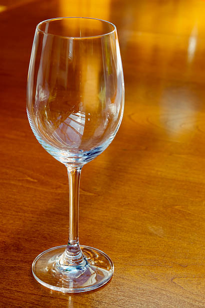 istock wine glass on wooden table 147038435