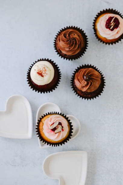 istock Delicious Chocolate, red velvet, raspberry cupcakes with white hearts 1470386007