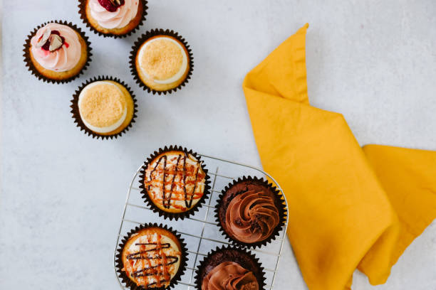 istock Delicious cupcakes on cooling rack with yellow napkin 1470386018