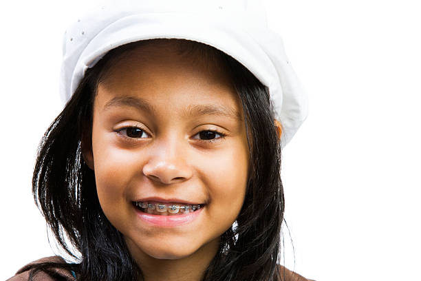 Latin American and Hispanic young girl smiling isolated over white