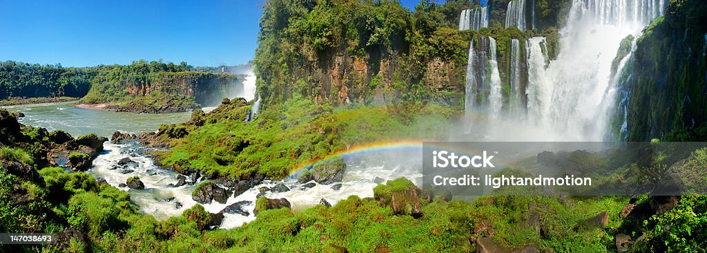 Iguazu Falls Iguazu Falls as seen from Argentina with lush greenery and a visible double rainbow. Argentina Stock Photo