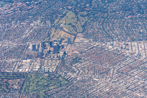 Aerial view of Addlestone in Surrey with the M25 motorway cutting the residential areas in two with Row Town to the upper part of the picture.  In the bottom left corner is Jubilee High School and to the top left is the Animal and Plant Health Agency.