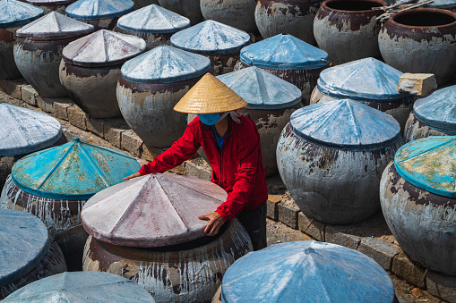 Worker is checking fish sauce brew jars in Mui Ne district, Phan Thiet, Binh Thuan province, central Vietnam