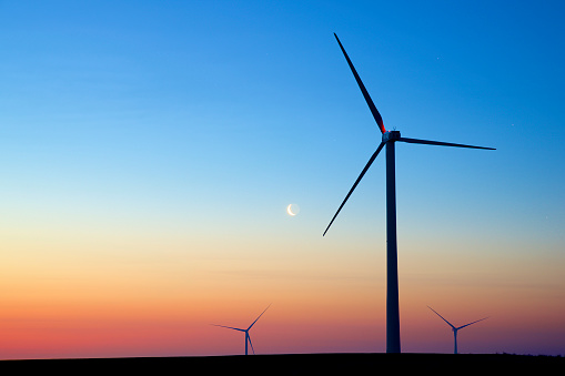 Silhouettes of a group of wind turbines at sunrise. in Spain, Aragon, Pozuelo de Aragón
