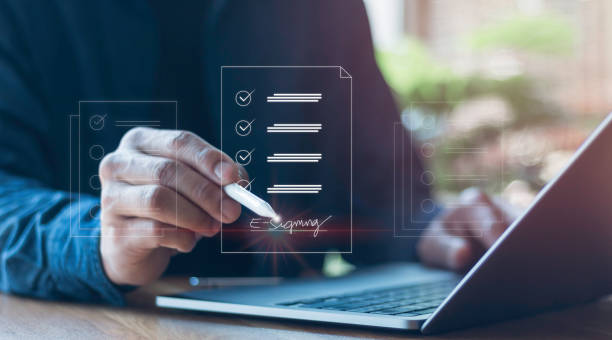 istock E-signing, management Paperless workplace, electronic signature, document management man signs an electronic document on a digital document by virtual notebook screen using a stylus 1470390125