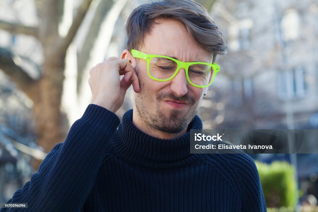 Young man having hearing loss Tinnitus Stock Photo