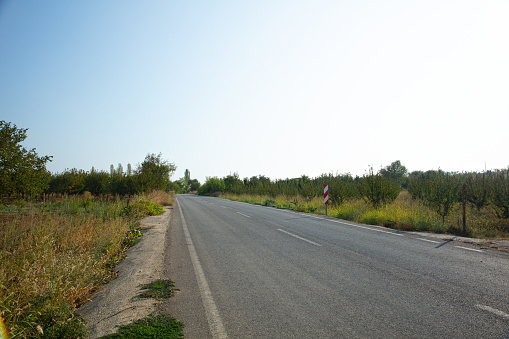 Asphalt road leading to the village