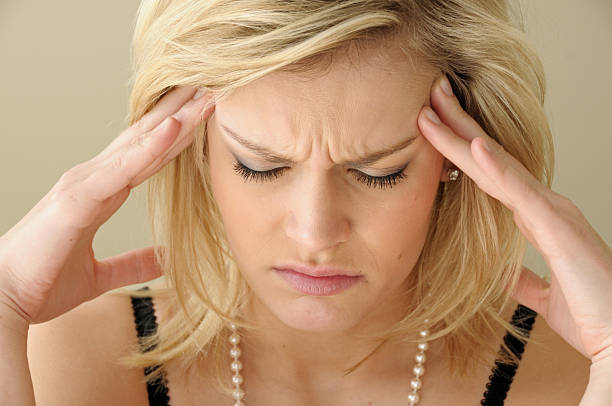 Young woman with headache stock photo