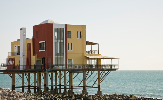 A building in Puerto Penasco (Rocky Point) Mexico built on stilts over the beach.