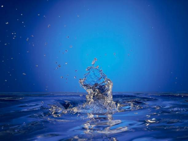 Close up of splashing water droplet. Blue Background