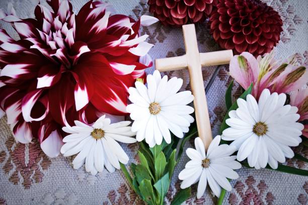 Wooden Religious Cross with Flowers A wooden religious cross with flowers for a religion or easter background. religious equipment photos stock pictures, royalty-free photos & images