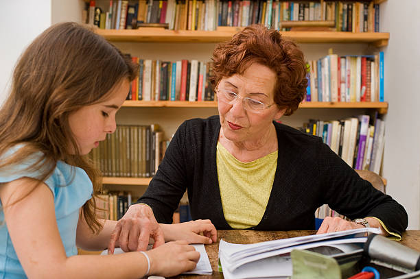 Free Stock Photo of Granddaughter doing homework with older relative ...