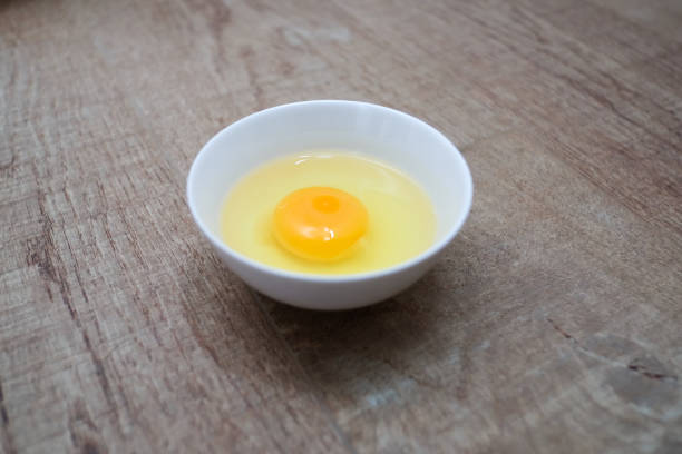 istock Fresh raw egg bowl on white background with Light and shadow from the window in the morning, selective focus. 1470406762
