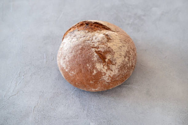 istock Freshly baked bread loaves on concrete background. 1470409328