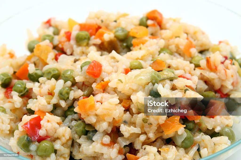 Close-up image of rice with peas and carrots  Stewed rice with the vegetables, prepared from the frozen half-finished products. Carrot Stock Photo