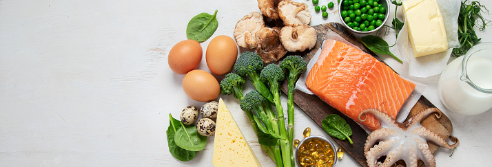 Composition with products rich in vitamin D on white background, top view. Panorama with copy space.