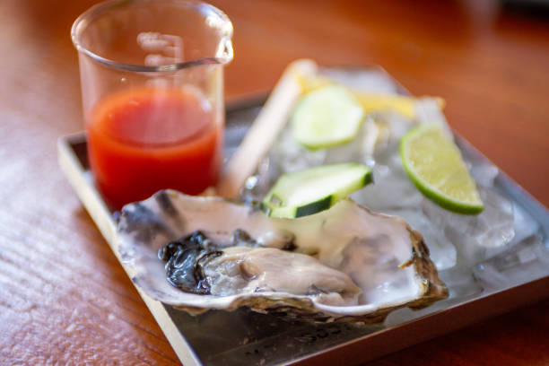 Single oyster with cocktail sauce