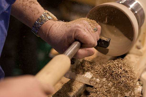 carving a wood bowl with a lathe stock photo