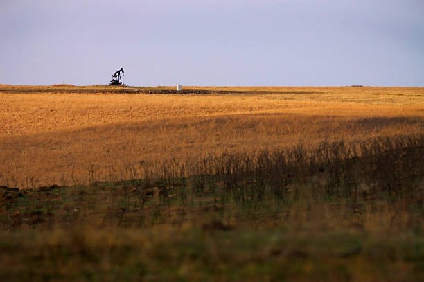 Oil rig on prairie horizon stock photo