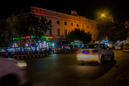 Horizontal photograph of the night traffic on the roads of Connaught Place located in Delhi