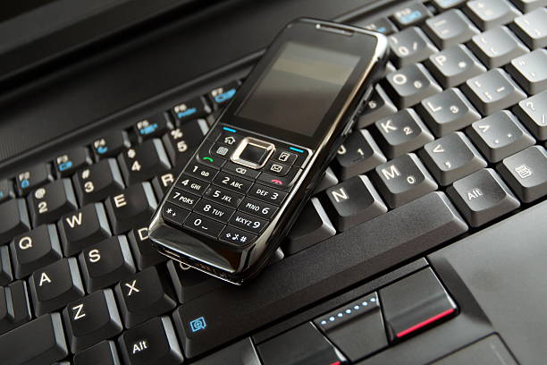 istock Mobile phone and laptop keyboard(clean!) 147041275