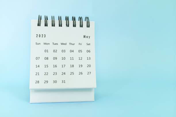 istock Selective focus of May 2023 desk calendar on blue background with copy space. 1470413637