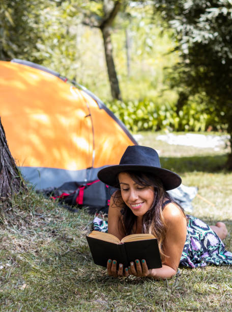 istock Woman Lying on the Grass with a Book on a Sunny Day 1470413700