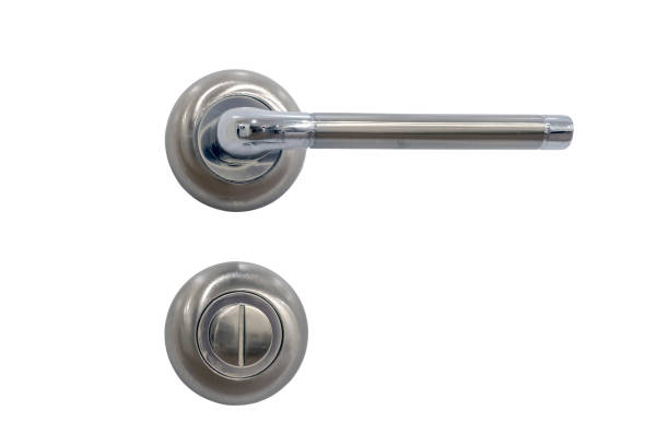 istock Metal handle with a rotary lock on a white half-open door, close-up, isolated on a white background. The element door in the style of French Provence 1470414963