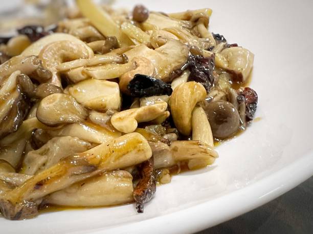 Chinese mixed mushroom vegetarian dish Close-up of a plate of Chinese mixed mushroom vegetarian dish matsutake mushroom stock pictures, royalty-free photos & images