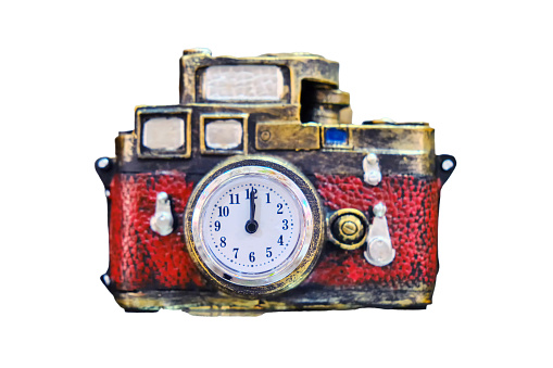 A camera with a clock instead of a lens is a concept of a time machine, isolated on a white background. Red gift transfers to the past or future.