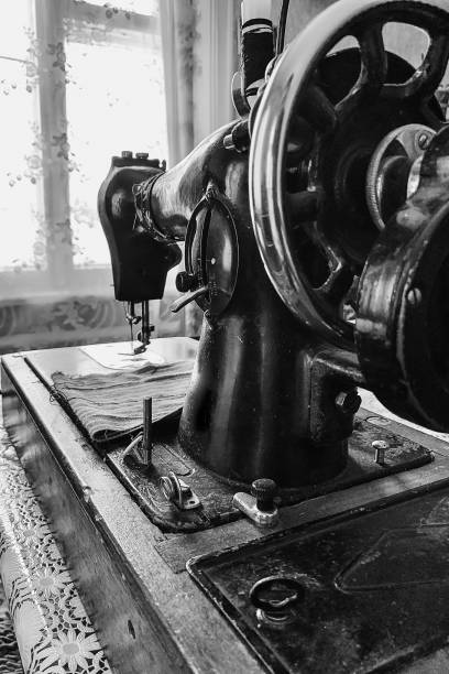 istock Old sewing machine stands on the table at home ready to work and sew. 1470415644