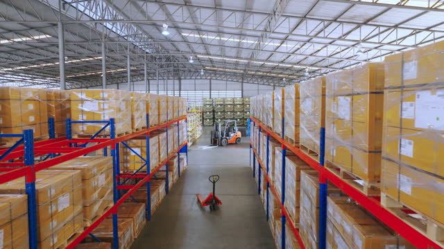Warehouse interior.Aerial view moving between shelves palettes with ordered goods and materials at warehouse. Large warehouse logistics terminal.