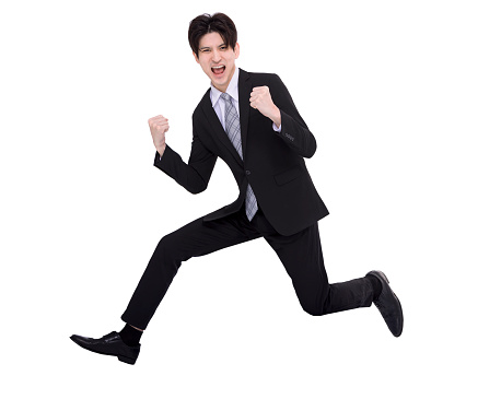 Excited business man running and jumping in the air with success gesture