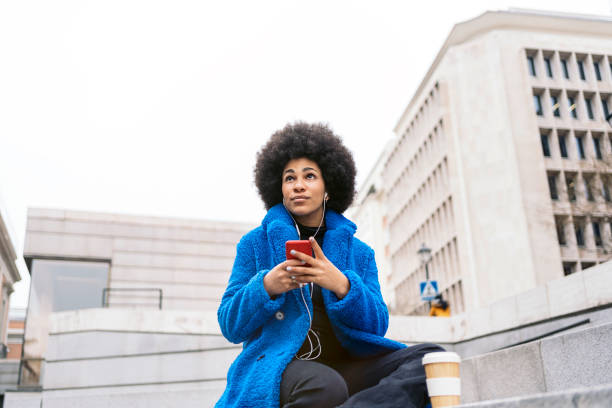 istock Afro Girl Using Phone 1470416890