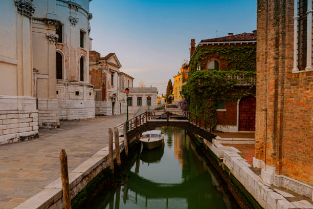 istock A canal in venice with a bridge and a boat on it 1470419562