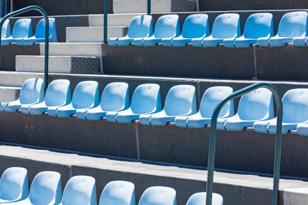 istock Rows of plastic seating in a stadium at a community baseball field 1470419605