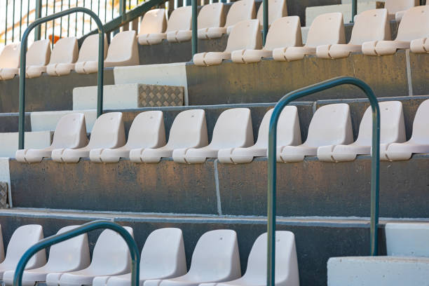istock Rows of plastic seating in a stadium at a community baseball field 1470419609