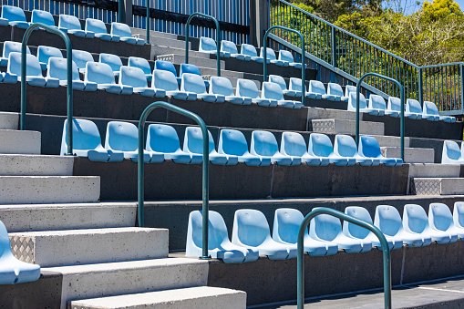 Rows of plastic seating in a stadium at a community baseball field