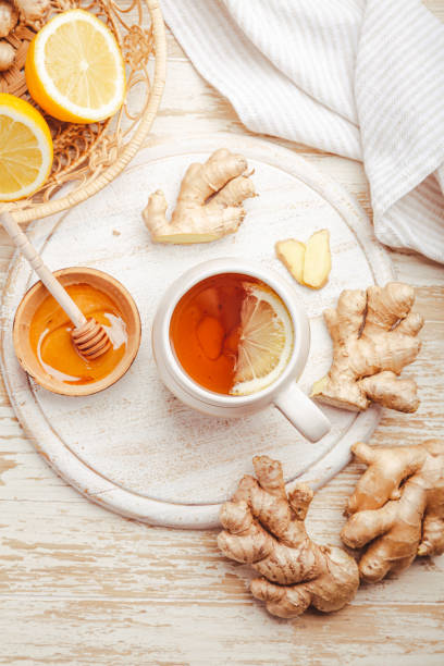 istock Ginger tea with lemon and honey on a wooden table 1470420488