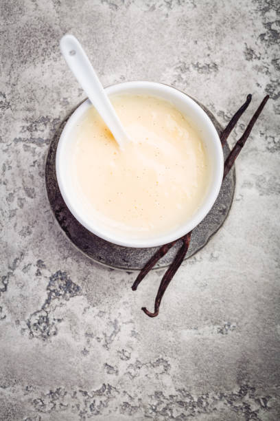 istock Homemade vanilla sauce in small bowl on grey background 1470420494
